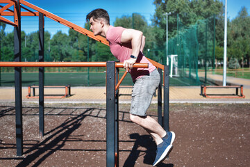Young Man Performing Dips Exercise at Outdoor Workout Gym