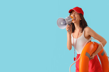 Female lifeguard with rescue ring shouting into megaphone on blue background