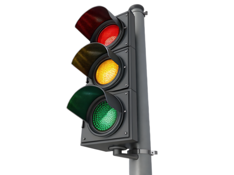 A traffic light with red yellow and green lights illuminated against a black background isolated view