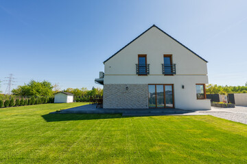 Side view of new build house with freshly cut grass