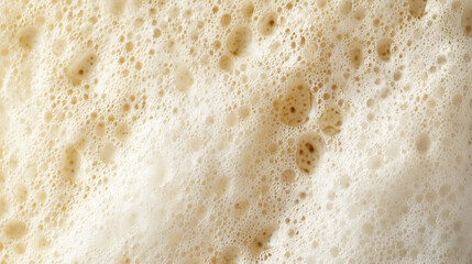 A detailed macro shot of beer foam, displaying the bubbly texture and its refreshing look.