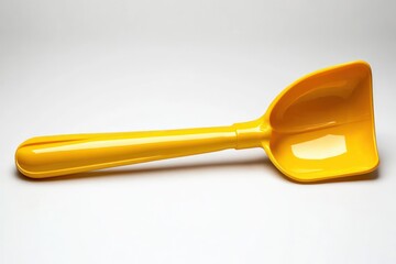 bright yellow plastic scoop with a smooth glossy surface on a plain white background