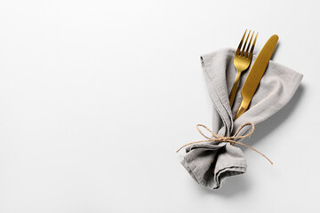 Stylish golden cutlery on grey background