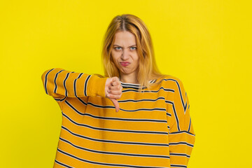 Dislike. Upset unhappy Caucasian woman showing thumbs down sign gesture, expressing discontent,...