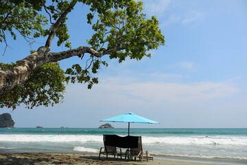 beautifull tropical beach on blue sky and beach chairs