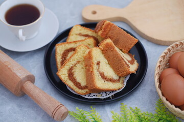 Delicious cake slices with a cup of tea on a table