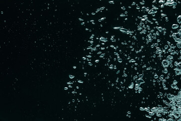 Many water bubbles on black background, closeup. Space for text