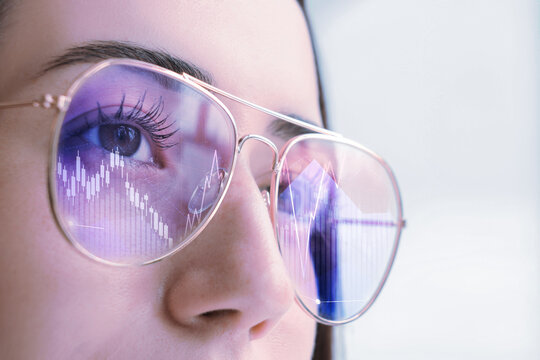 Stock exchange. Trader analyzing data, closeup. Graphs reflecting in her eyeglasses