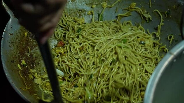  stir-fried noodles with a ladle, yogyakarta javanese noodles capture steam and movement. Perfect for food blogs, restaurants, cooking tutorials, and recipe books