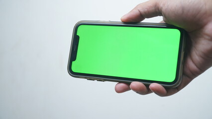 Man hold smartphone with chroma green screen