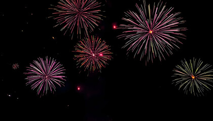 Exploding Fireworks Display with Red Pink and Yellow Hues in a Dark Night Sky