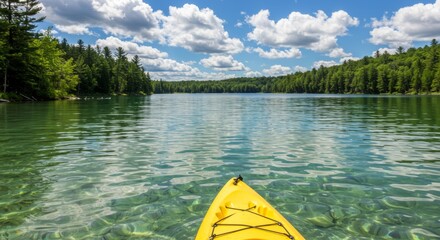 Yellow Kayak on a Calm, Clear Lake Surrounded by Lush Green Trees under a Sunny Sky
