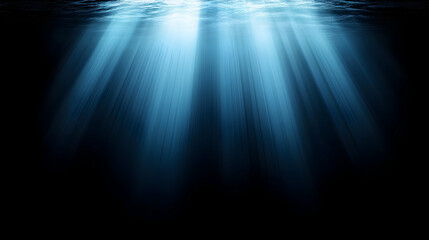 Dramatic underwater scene with sunbeams penetrating deep ocean darkness; perfect for background or design.