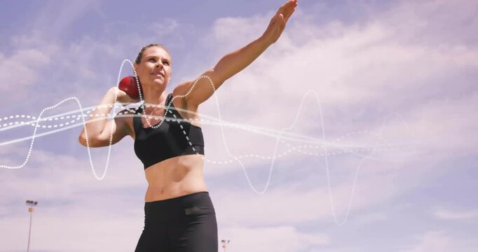 female athlete preparing shot put outdoors, showcasing health tech using animated waveform overlay
