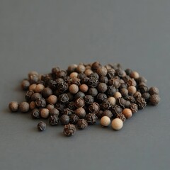 Pile of mixed peppercorns on a gray surface