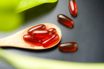 wooden spoon with soft gels, Fish oil capsules, omega 3, omega 9, vitamin D, vitamin E