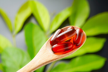 wooden spoon with soft gels, Fish oil capsules, omega 3, omega 9, vitamin D, vitamin E