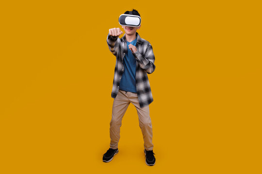Fototapeta Child Using a Gaming Gadget for Virtual Reality on Yellow Background