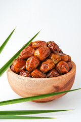 Dates fruit sukari or kurma sukari, in wooden bowl isolated on white background