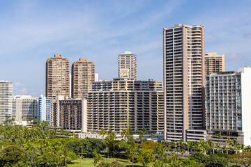 Tall Modern Buildings in Honolulu Hawaii Surrounded by Lush Vegetation and Blue Sky