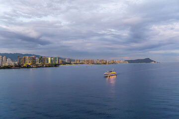 Scenic Evening View of Honolulu Skyline and Bay with a Passing Ship