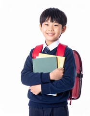 A smiling schoolboy in uniform proudly holds his books close to his chest