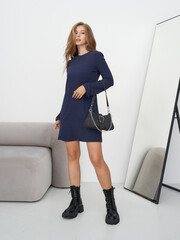 Model showcases chic fashion in a modern studio setting with elegant pose