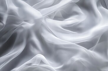 Obraz premium Soft, flowing white sheer fabric draped in elegant folds. A close-up view showcasing the delicate texture and subtle sheen