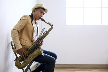 Portrait Of Professional Musician Saxophonist Man In Semi Formal Suit Plays Jazz Music On Saxophone