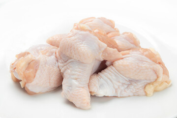 Pile of Fresh Raw Chicken Wing Stick Or Chicken Drumettes On White Background. Close-up
