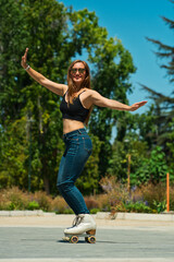 Beautiful blonde Latina wearing white skates, jeans, and glasses. Moving, dancing, and skating through the city, having lots of fun on a sunny day.