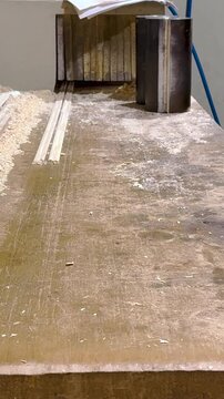 Portrait video of timber wood moulding machine processes and shapes planks with decorative profiles