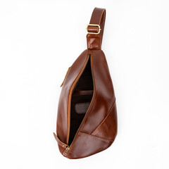 Blank and open brown leather sling bag isolated on white background, perfect for leather product...