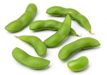 Edamame pods scattered on a white surface, showcasing fresh green soybeans
