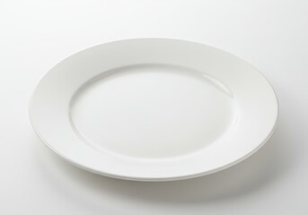 Simple white ceramic plate on a white surface for food presentation or design