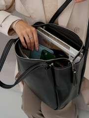 Elegant woman with a stylish handbag, exuding sophistication in a studio