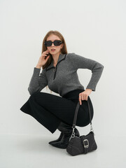 Striking fashion model poses on a minimalistic studio backdrop showcasing elegance