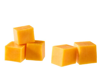 Cubes of cheddar cheese isolated on a white background.