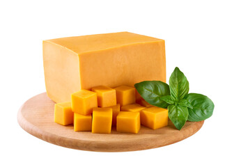 cheddar cheese sliced ​​into cubes with green basil on a cutting board isolated on a white background.