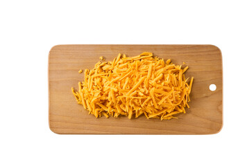grated cheddar cheese on a cutting board isolated on a white background, top view.