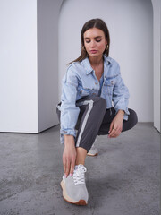 Stylish female model strikes a pose in a minimalist studio setting