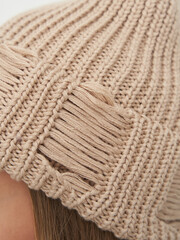 Elegant fashion model showcasing stylish knitwear in a cozy studio setting