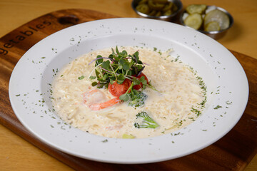 Shrimp cream risotto on a white plate
