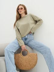 Fashion model showcases elegant style in studio setting during a contemporary photoshoot
