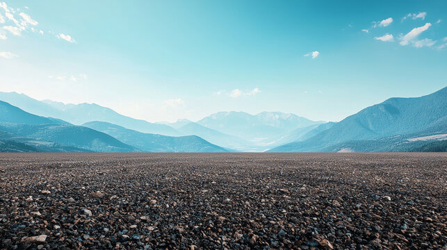 wide-angle ground with a clear sky and mountainous background for vehicles or products placement. Copy space image. Place for adding text or design