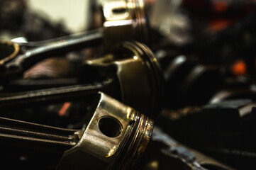 Fototapeta premium Close-up of metal parts of a car engine and mechanical details symbolizing industrial equipment, precision engineering and mechanical processes, selective focus, low key, background