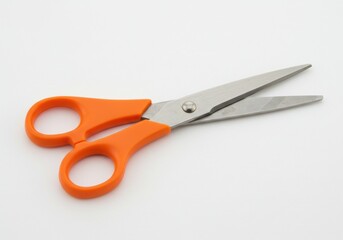 A pair of scissors with orange handles isolated on white background