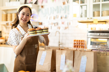Small business owners are selling .Asian bakery  cake shop owner enjoy posting picture and review her cake on social media or online marketing streaming publish for advertising small business making m