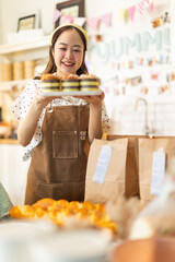 Small business owners are selling .Asian bakery  cake shop owner enjoy posting picture and review her cake on social media or online marketing streaming publish for advertising small business making m
