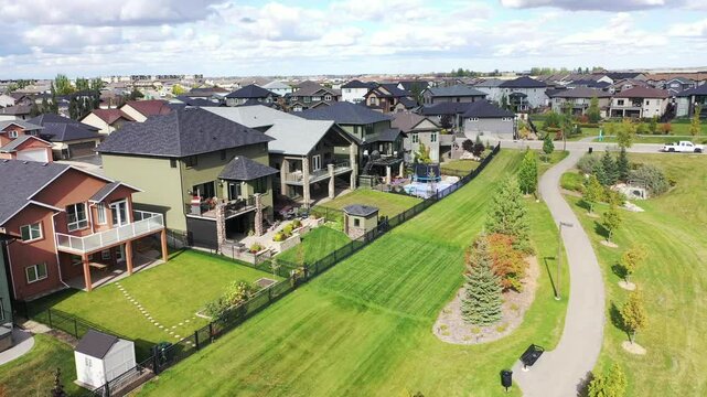 Residential neighborhood with houses and a park. The houses are mostly white and the park is green